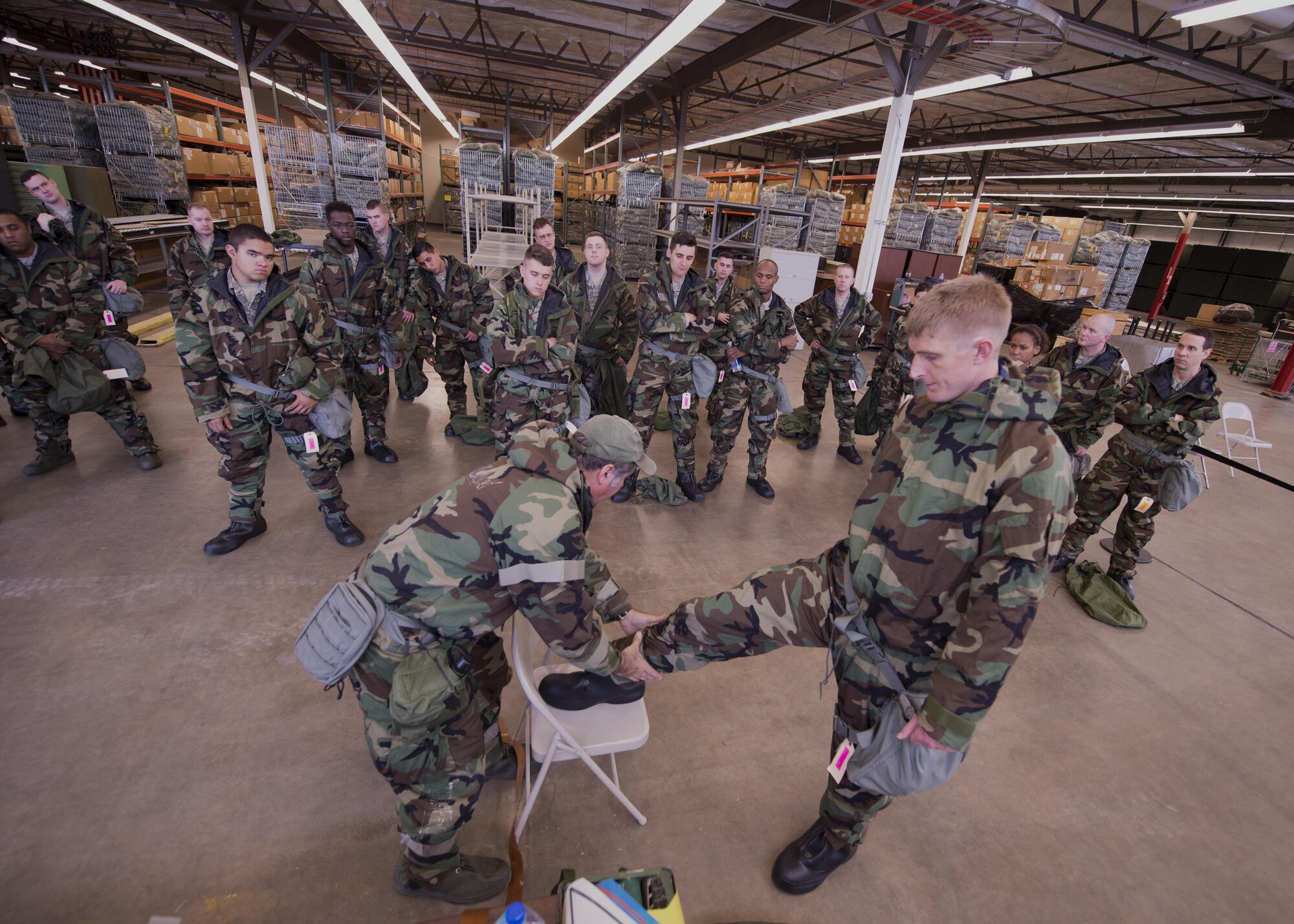 Tech. Sgt. Michael Connolly, 434th Security Forces Squadron fire team leader, right, and Daniel DeAngulo, 434th Mission Support Group base emergency manager, demonstrate proper wear of and contamination detection of M-9 tape during chemical, biological, radiological and nuclear defense [CBRNE] training at Grissom Air Reserve Base, Ind. Oct. 14, 2017.