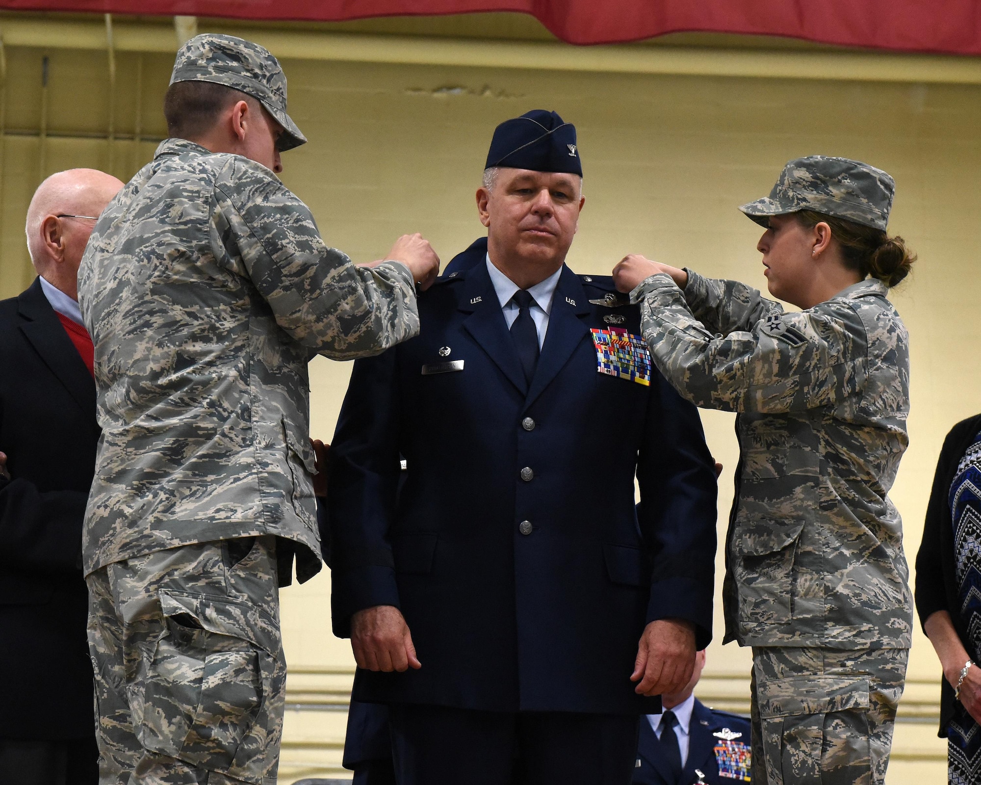 U.S. Air Force Brig. Gen. William P. Robertson has his son, 2nd Lt. James Robertson and his daughter, Airman 1st Class Elizabeth Robertson, remove the colonel devices on his service dress coat and replace them with brigadier general devices during Robertson's promotion ceremony in Peoria, Ill. Nov. 4, 2017.  With the promotion, Robertson becomes the chief of staff for the Illinois Air National Guard, after serving 13 years as the commander of the 182nd Airlift Wing. (U.S. Air National Guard photo by Master Sgt. Todd Pendleton)