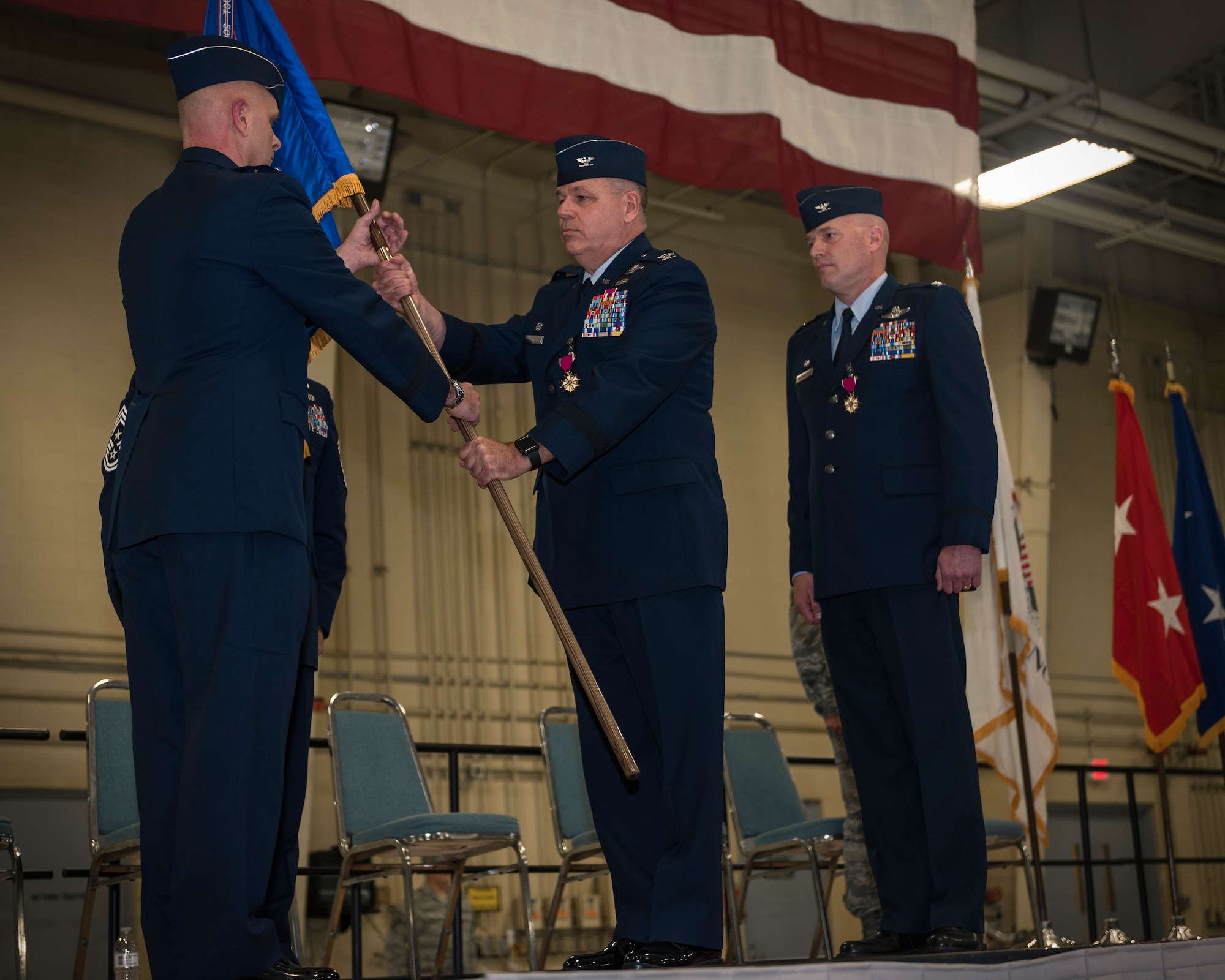 U.S. Air Force Col. William Robertson, center, the commander of the 182nd Airlift Wing, Illinois Air National Guard, relinquishes command to Maj. Gen. Ron Paul, the assistant adjutant general – Air of the Illinois National Guard, during a change of command ceremony in Peoria, Ill., Nov. 4, 2017. Col. Daniel McDonough, right, replaced Robertson, who became the chief of staff for the Illinois Air National Guard upon his promotion to brigadier general during the ceremony. (U.S. Air National Guard photo by Tech. Sgt. Lealan Buehrer)