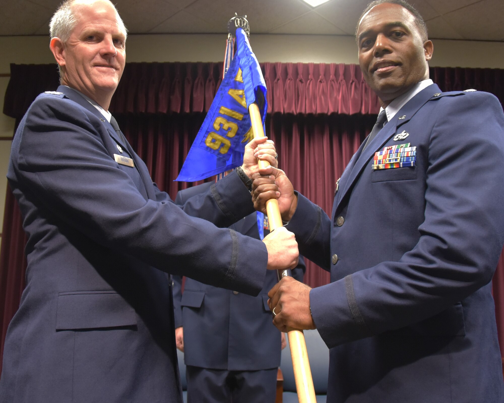 Lt. Col. Bryan Alston receives the 931st Civil Engineer Squadron guidon from Col. Eric Vitosh, 931st Air Refueling Wing commander, during a change of command ceremony Nov. 5, 2017, at McConnell Air Force Base, Kan.  Alston has more than 20 years of experience in civil engineering, general contracting and project management in both the public and private sectors.