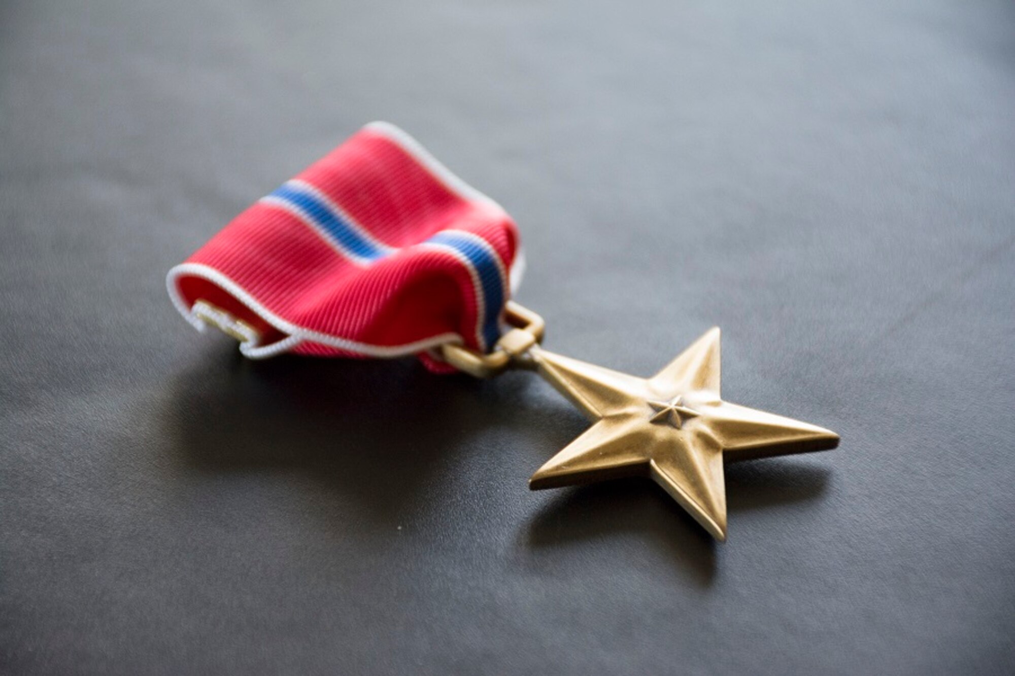 The Bronze Star, depicted here, is authorized by Executive Order No. 9419 on Feb. 4, 1944, and is awarded to a person in any branch of the military service who, while serving in any capacity with the armed forces of the United States on or after Dec. 7, 1941, who shall have distinguished him or her self by heroic or meritorious achievement or service, not involving participation in aerial flight, in connection with military operations against an armed enemy. (U.S. Air Force Photo/Maj. Jon Quinlan)