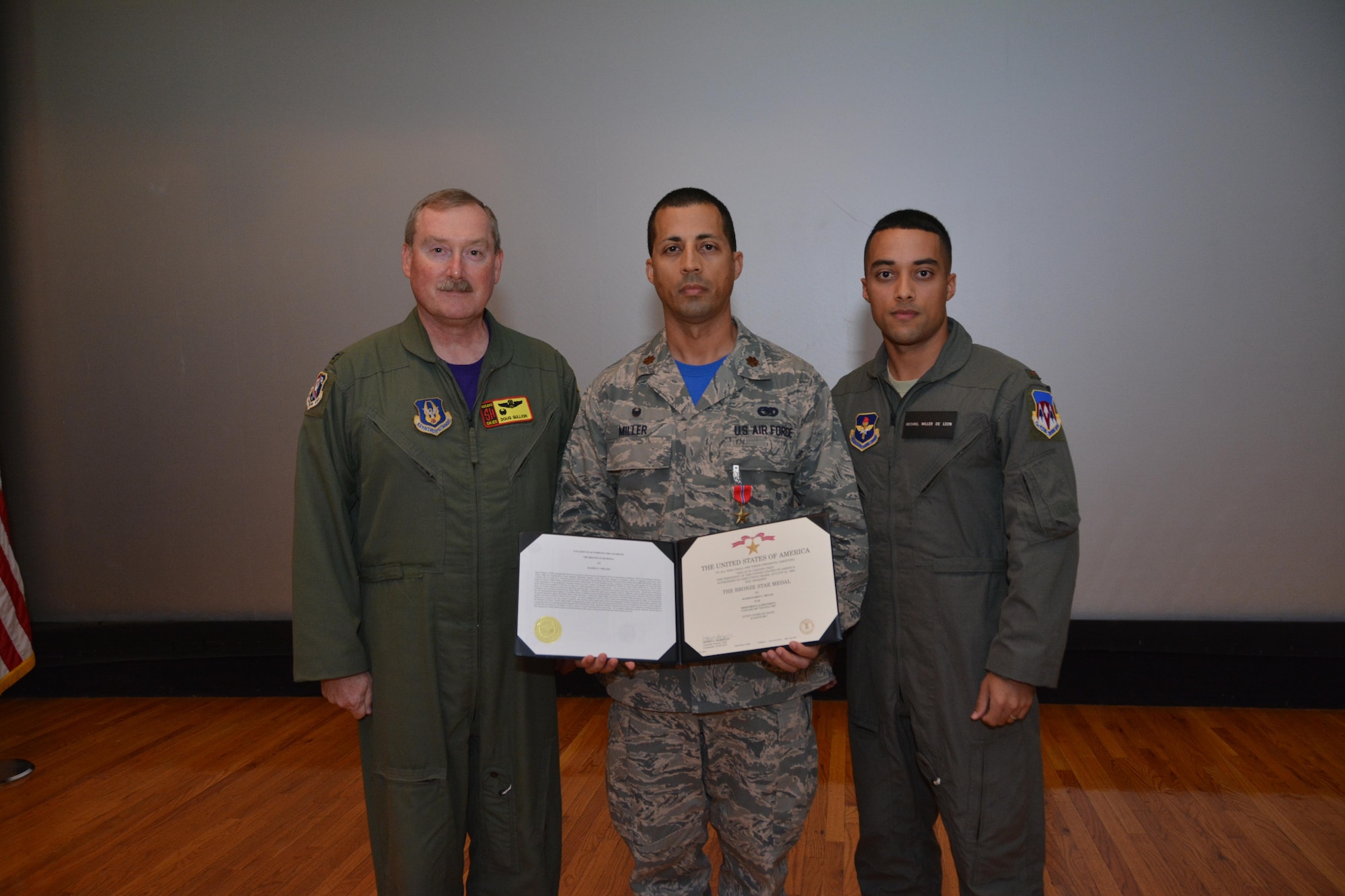 Maj. Damien Miller, (middle) 507th Logistics Readiness Squadron commander, poses with his brother, 2nd Lt. Michael Miller (right) and Col. Doug Gullion, 507th Air Refueling Wing commander, during a Bronze Star Medal presentation here, Nov. 5, 2017.  Maj. Miller received the medal for meritorious service in Iraq from Jan. 7 to July 8, 2017, while serving as the 442nd Air Expeditionary Squadron commander. Miller was responsible for: Logistics, materiel management, vehicle management, transportation, traffic management and aerial port operations. Additionally, Miller commanded six geographically separated units while exposed to extreme danger from hostile rocket and mortar attacks and credible threats from improvised explosive devices. (U.S. Air Force Photo/Tech Sgt. Samantha Mathison)
