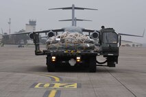 A U.S. Airman waits to see if any other supplies are needed for an aeromedical evacuation mission on the flightline of Ramstein Air Base, Germany, Oct. 26, 2017. Several units lend a hand in order for the weekly patient movements to be successful.