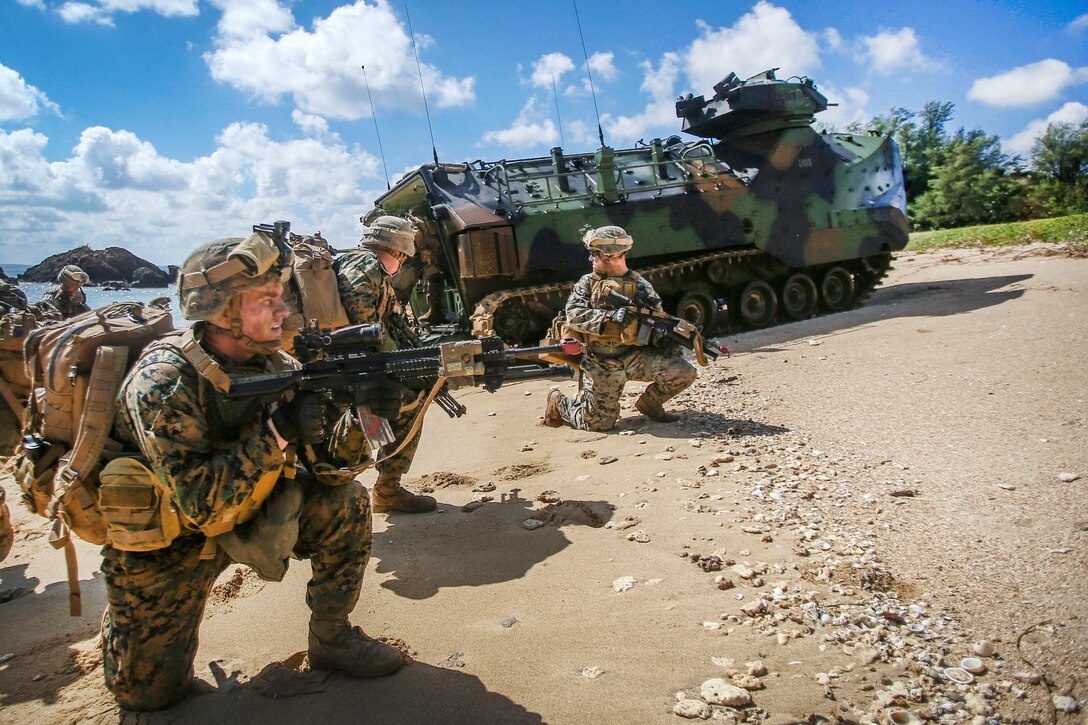 Marines exit a vehicle onto the beach during an amphibious landing exercise during Blue Chromite 18 at Kin Blue Beach in Okinawa, Japan.