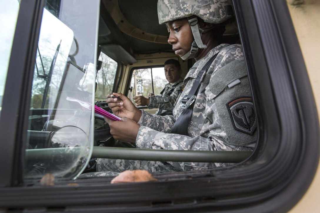 Army Spc. Anansa Parham goes over mission documents while getting ready for Operation Take Back New Jersey.