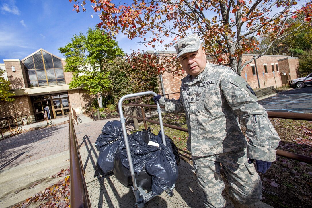 Army Staff Sgt. Roger Galvez pushes a cart full of prescription drugs during Operation Take Back New Jersey.