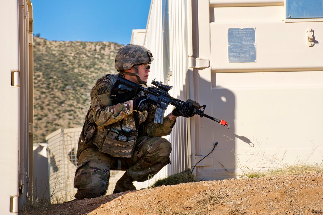 A soldier provides security while members of his team assault a mountain village during exercise Vigilant Shield at White Sands Missile Range, N.M.