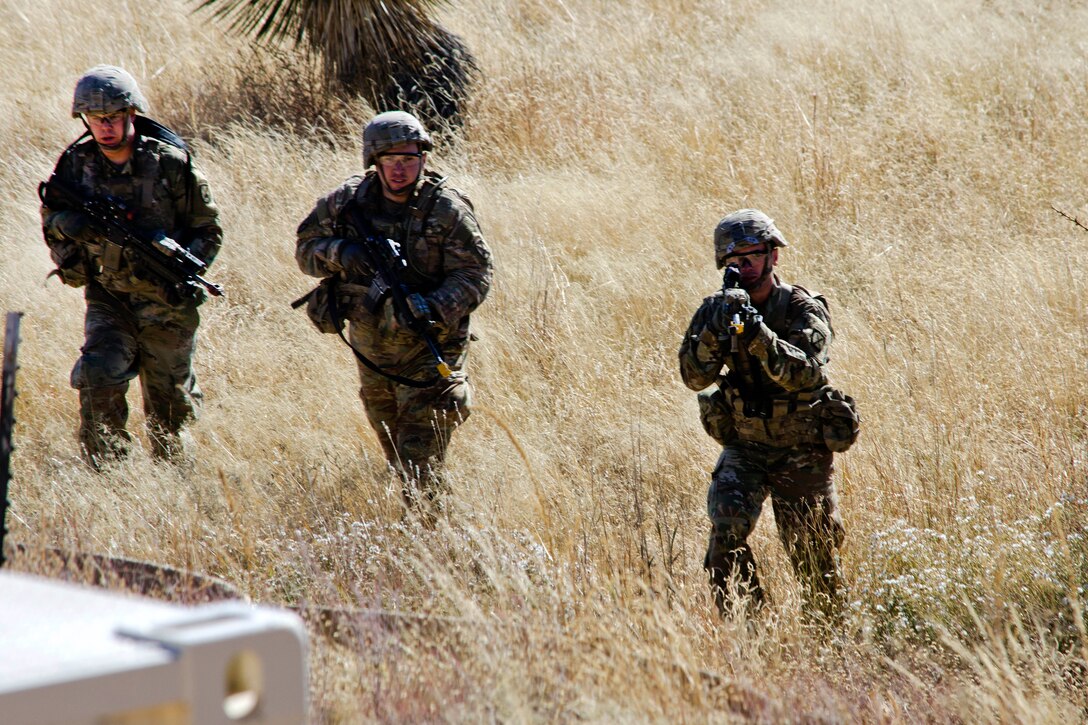 Solders maneuver toward mountain village during the Vigilant Shield Exercise at White Sands Missile Range, N.M.