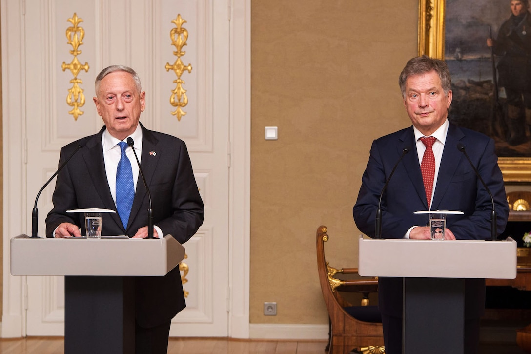 Defense Secretary Jim Mattis and the Finnish president stand behind podiums.