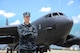 U.S. Navy Lt. Andrew Willes stands in front of a B-52 on a flightline at Barksdale AFB, Louisiana.