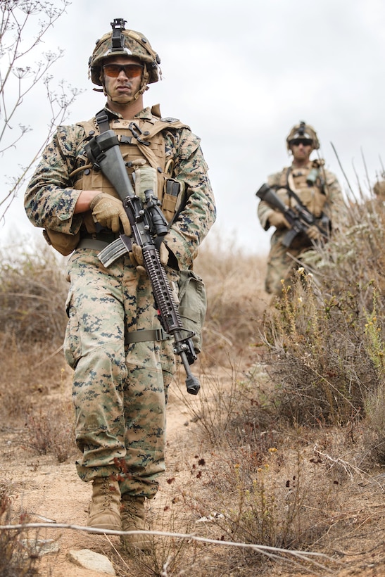 Marine Corps Cpl. Michael Malley, left, participates in a mock patrol during a Sapper Leaders Course at Camp Pendleton, Calif.