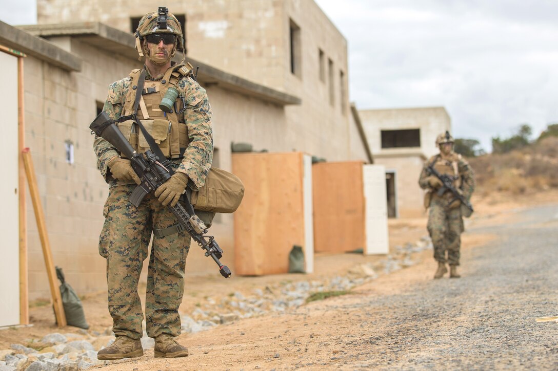 Marine Corps Lance Cpl. Nathan Long, left, participates in a mock patrol during a military operation on urban terrain exercise part of a Sapper Leaders Course on Camp Pendleton, Calif.