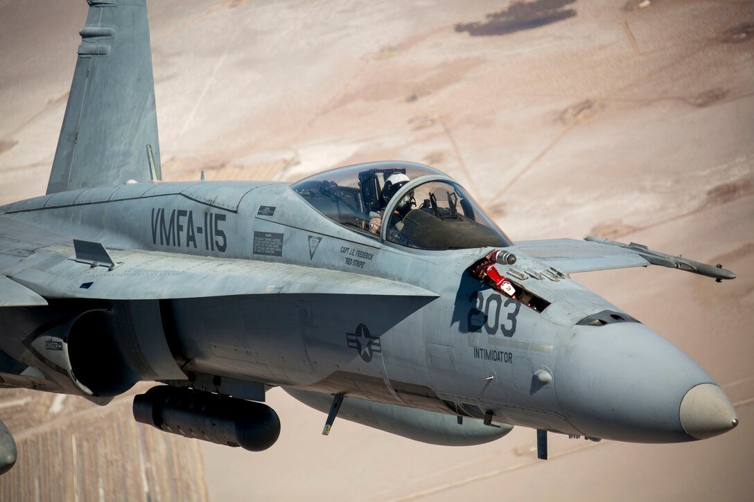 An F/A-18C Hornet flies over the California desert.