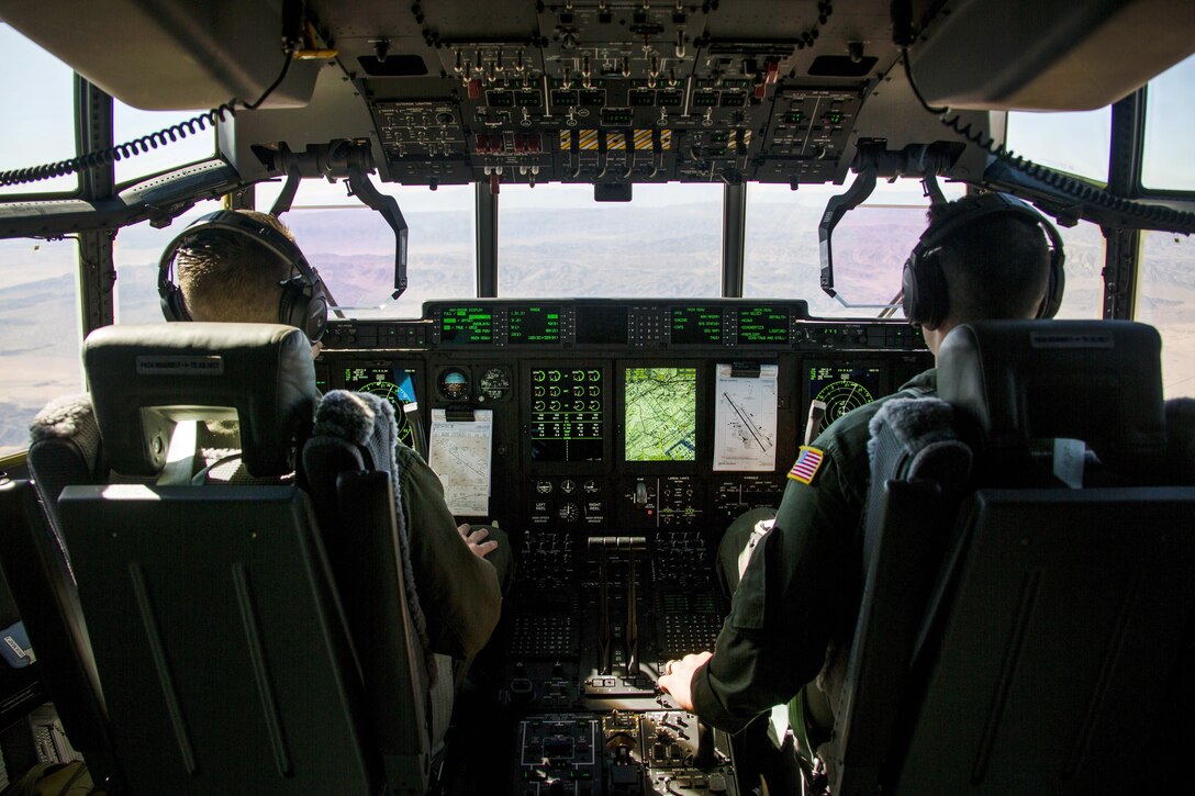 Marine Corps pilots in the cockpit of a KC-130J Super Hercules.