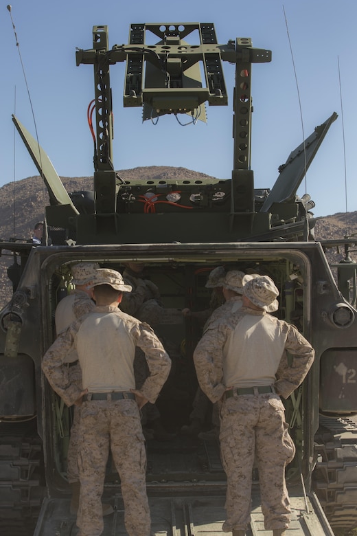 Marines with 3rd Assault Amphibious Battalion perform an operations check on their Amphibious Assault Vehicle before employing the Mine Clearing Line Charge at Range 114 aboard the Marine Corps Air Ground Combat Center, Twentynine Palms, Calif., Oct. 26, 2017. Unlike current amphibious breaching systems, the MICLIC will allow a breach lane that provides maneuverability for assault forces as they push forward to provide fire and maneuver on enemy defended beaches that are manned with explosives. (U.S. Marine Corps photo by Cpl. Dave Flores)