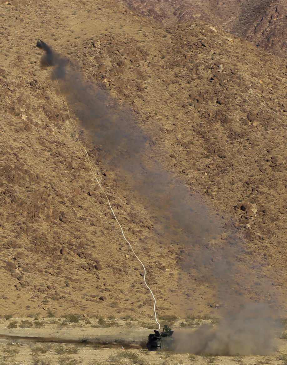 An Amphibious Assault Vehicle fires a Mine Clearing Line Charge from a Mark-154 Mod 1 Launcher at Range 114 aboard the Marine Corps Air Ground Combat Center, Twentynine Palms, Calif., Oct. 26, 2017. Unlike current amphibious breaching systems, the MICLIC will allow a breach lane that provides maneuverability for assault forces as they push forward to provide fire and maneuver on enemy defended beaches that are manned with explosives. (U.S. Marine Corps photo by Cpl. Christian Lopez)
