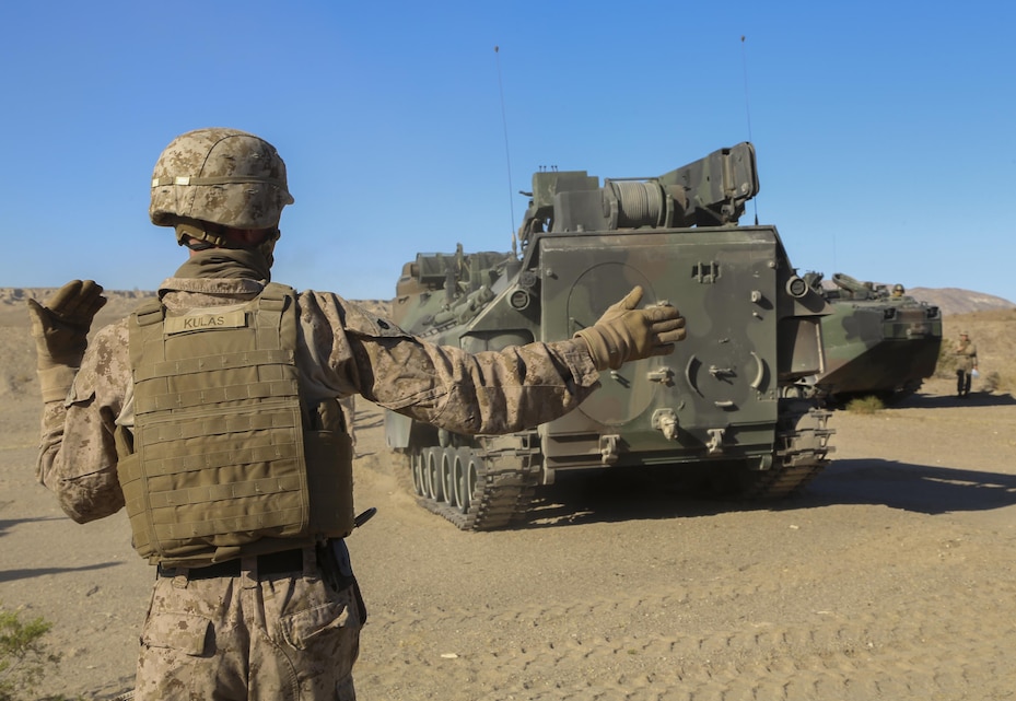 Staff Sgt. Austin Kulas, 3rd Assault Amphibious Battalion, guides the Amphibious Assault Vehicle during a field test to load a Mine Clearing Line Charge in a Mark-154 Mod 1 Launcher at Range 114 aboard the Marine Corps Air Ground Combat Center, Twentynine Palms, Calif., Oct. 26, 2017. Unlike current amphibious breaching systems, the MICLIC will allow a breach lane that provides maneuverability for assault forces as they push forward to provide fire and maneuver on enemy defended beaches that are manned with explosives. (U.S. Marine Corps photo by Cpl. Christian Lopez)