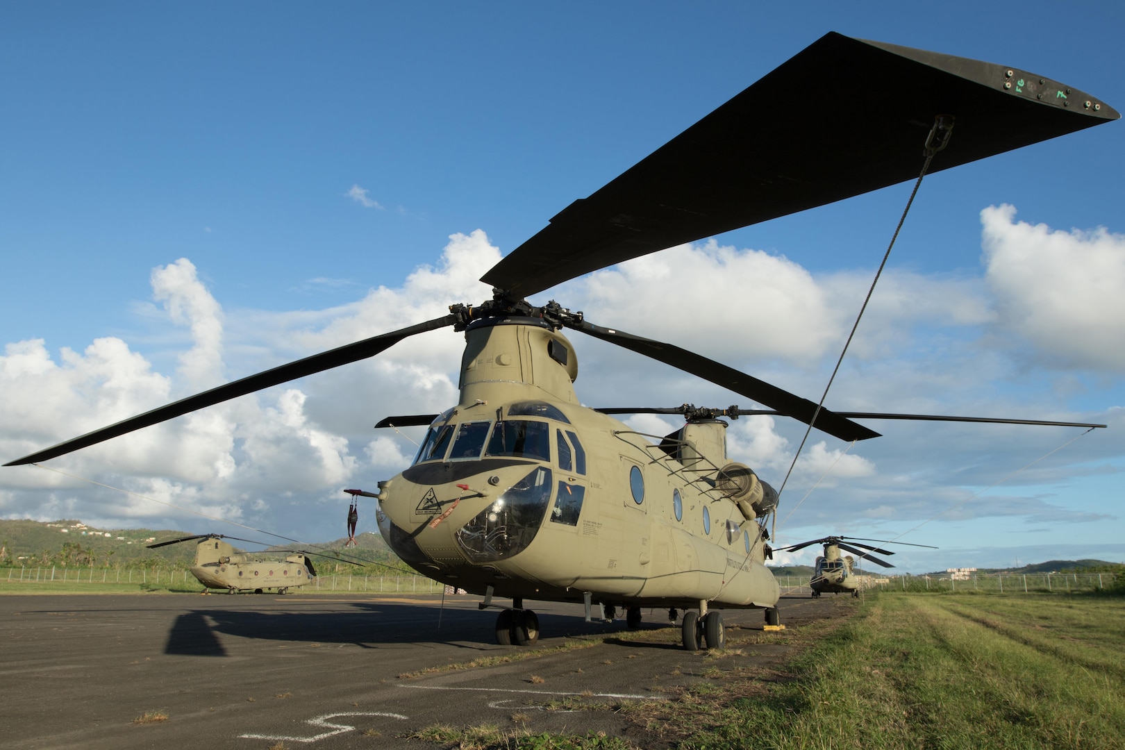 A CH-47 Chinook helicopter sits on the airfield at Roosevelt Roads, Puerto Rico, Nov. 2, 2017. Chinooks are being used to deliver aid to the worst-hit and most remote areas of Puerto Rico as part of the ongoing relief and recovery efforts after the island territory was hit by Hurricanes Irma and Maria. Army photo by Spc. Samuel D. Keenan