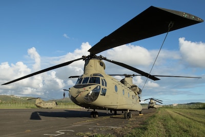A CH-47 Chinook helicopter sits on the airfield at Roosevelt Roads, Puerto Rico, Nov. 2, 2017. Chinooks are being used to deliver aid to the worst-hit and most remote areas of Puerto Rico as part of the ongoing relief and recovery efforts after the island territory was hit by Hurricanes Irma and Maria. Army photo by Spc. Samuel D. Keenan