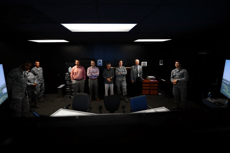 U.S. Airmen assigned to the 20th Fighter Wing and members of the Shaw-Sumter Community Council (SSCC) watch a flightline simulator at the 20th Operations Support Squadron air traffic control tower at Shaw Air Force Base, South Carolina, Nov. 2, 2017.