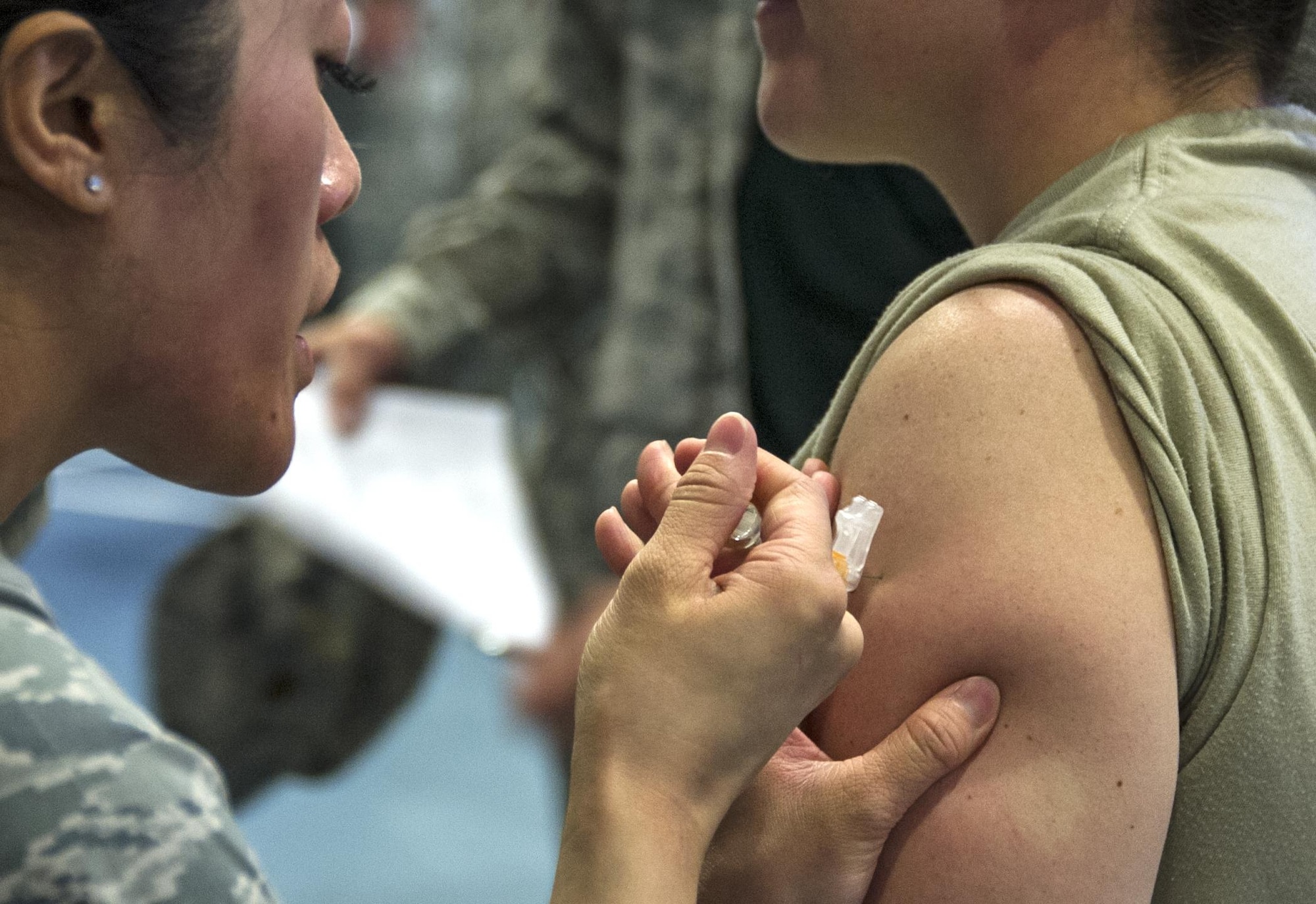 A member of the 310th Aerospace Medicine Flight administers the flu shot during the 310th Space Wing's commander's call on Sunday, Nov. 5, 2017.