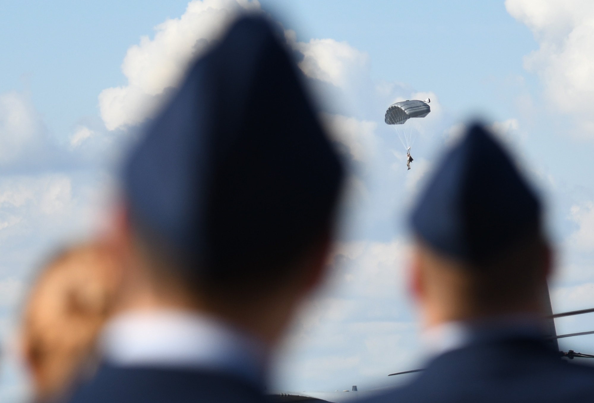 Mississippi high school Junior ROTC drill teams watch 334th Training Squadron battlefield Airmen conduct a parachute demonstration during the Fourth Annual Mississippi All-Services Junior ROTC Drill Competition Nov. 4, 2017, on Keesler Air Force Base, Mississippi. More than 400 Junior ROTC cadets, spectators and volunteers were in attendance where cadets battled for the best all-services Junior ROTC team in Mississippi. Thirteen Junior ROTC teams from all military branches were represented at the event with the Pearl High School Navy Junior ROTC earning the top honors. (U.S. Air Force photo by Kemberly Groue)