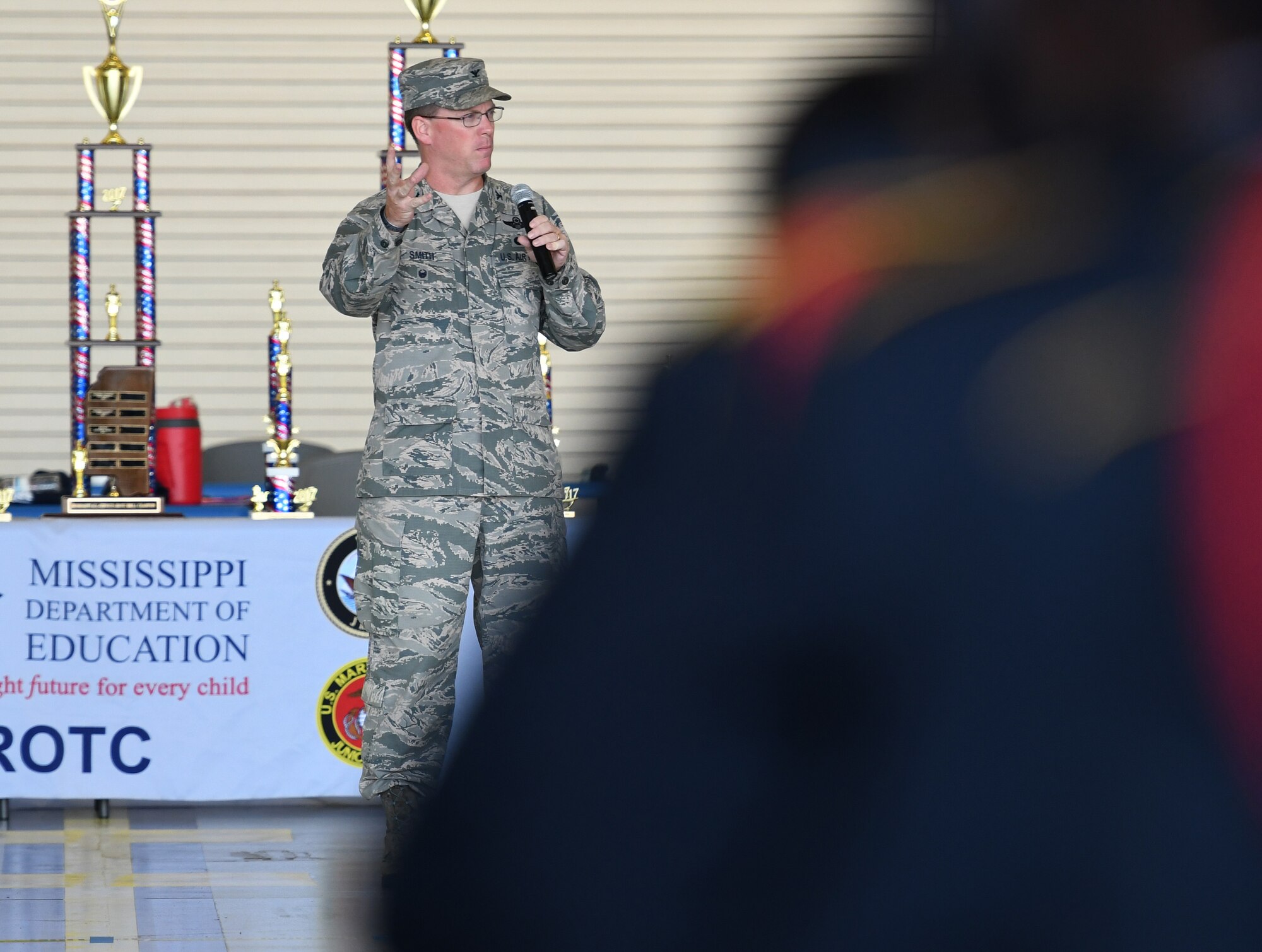 Col. C. Mike Smith, 81st Training Wing vice commander, delivers closing remarks during the Fourth Annual Mississippi All-Services Junior ROTC Drill Competition Nov. 4, 2017, on Keesler Air Force Base, Mississippi. More than 400 Junior ROTC cadets, spectators and volunteers were in attendance where cadets battled for the best all-services Junior ROTC team in Mississippi. Thirteen Junior ROTC teams from all military branches were represented at the event with the Pearl High School Navy Junior ROTC earning the top honors. (U.S. Air Force photo by Kemberly Groue)