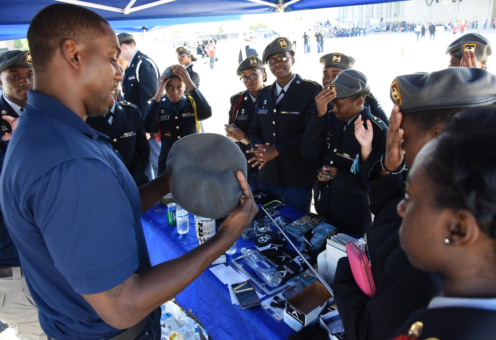 Tech. Sgt. Cornelius Bostic, 331st Recruiting Squadron recruiter demonstrates the proper way to wear a beret to members of the Starkville High School Army Junior ROTC during the Fourth Annual Mississippi All-Services Junior ROTC Drill Competition Nov. 4, 2017, on Keesler Air Force Base, Mississippi. More than 400 Junior ROTC cadets, spectators and volunteers were in attendance where cadets battled for the best all-services Junior ROTC team in Mississippi. Thirteen Junior ROTC teams from all military branches were represented at the event with the Pearl High School Navy Junior ROTC earning the top honors. (U.S. Air Force photo by Kemberly Groue)