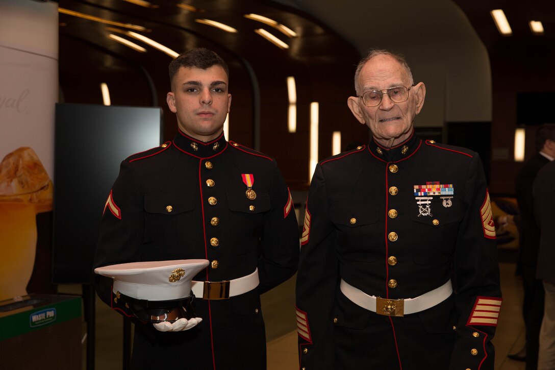 Pfc. Alec J. Page, the youngest Marine present at the Marine Forces Reserve birthday ball, and Gunnery Sgt. (retired) Robert L. Allen, oldest Marine present, pose for a photo at the 242nd Marine Corps birthday ball hosted by Marine Forces on Nov. 3, 2017.