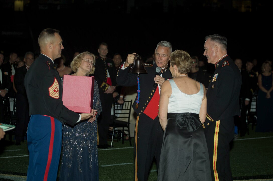 Lt. Gen. Rex C. McMillian (center), commander of Marine Forces Reserve and Marine Forces North presents Gen. Joseph F. Dunford (far right), the chairman of Joint Chiefs of Staff, a bell to symbolize the Reserve Force answering the call to mobilize at the Mercedes Benz Superdome, in New Orleans, Nov. 3, 2017.