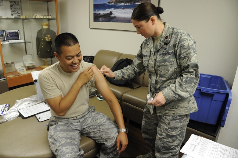 Airmen administers flus shot