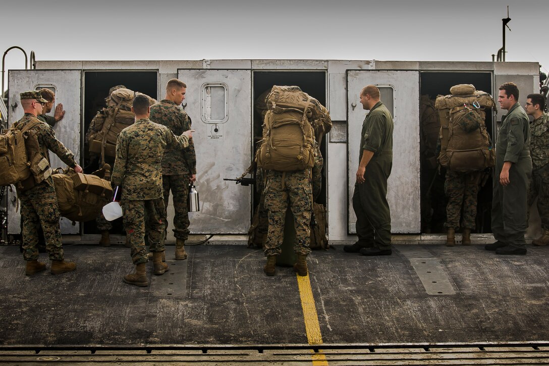 U.S. Marines and Sailors with the 26th Marine Expeditionary Unit (MEU) board U.S. Navy Landing Craft, Air Cushion 83, to embark on the amphibious assault ship USS Iwo Jima (LHD-7) as part of Composite Training Unit Exercise (COMPTUEX) at Onslow Beach, Camp Lejeune, N.C., Nov. 5, 2017. The 26th MEU is scheduled to conduct Composite Training Unit Exercise, its final pre-deployment training exercise in preparation for an upcoming deployment at sea.
