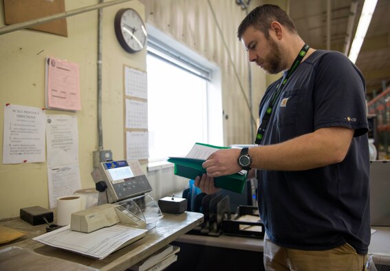 Brandon Durocher, Defense Logistics Agency disposition services, reads the guidelines for the certified scale at Joint Base Elmendorf-Richardson, Alaska, Nov. 3, 2017. The DLAs’ disposition services certified scales are now open to all military ID holders at no cost. Durocher is a material examiner and identifier for the DLA disposition services.