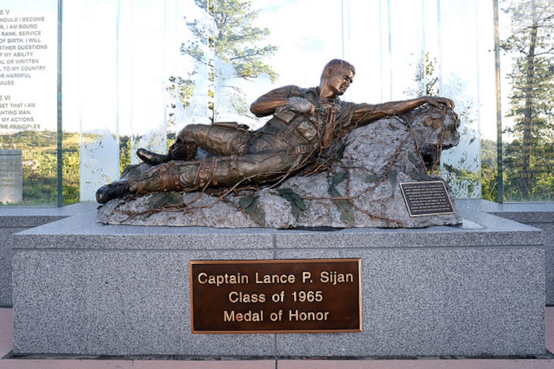 The Lance P. Sijan bronze statue is displayed at the U.S. Air Force Academy. Sijan was the first USAFA graduate to receive the Medal of Honor.