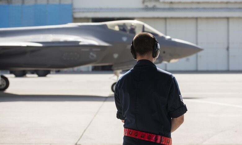 U.S. Air Force Staff Sgt. Zachary Kasperek, 34th Aircraft Maintenance Unit F-35A Lightning II crewchief, watches an F-35A  taxi for take-off at Kadena Air Base, Japan, Nov. 7, 2017. Approximately 300 Airmen and 12 F-35As from Hill Air Force Base, Utah’s 388th and 419th Fighter Wings are deployed to Kadena AB for a six-month planned rotation.  (U.S. Air Force photo by Senior Airman Omari Bernard)