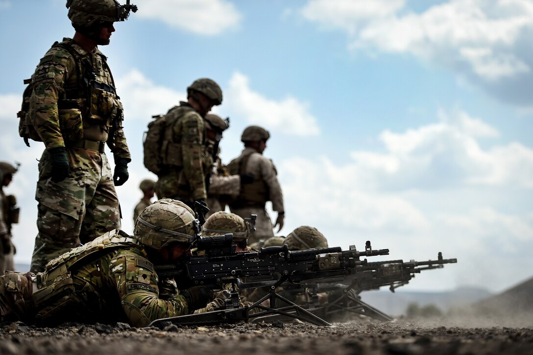 Soldiers fire M240 machine guns.