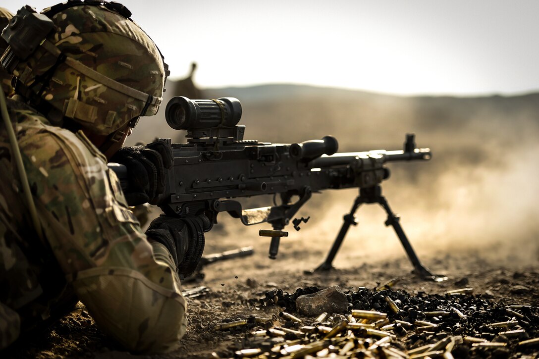 A soldier fires his M240 machine gun.