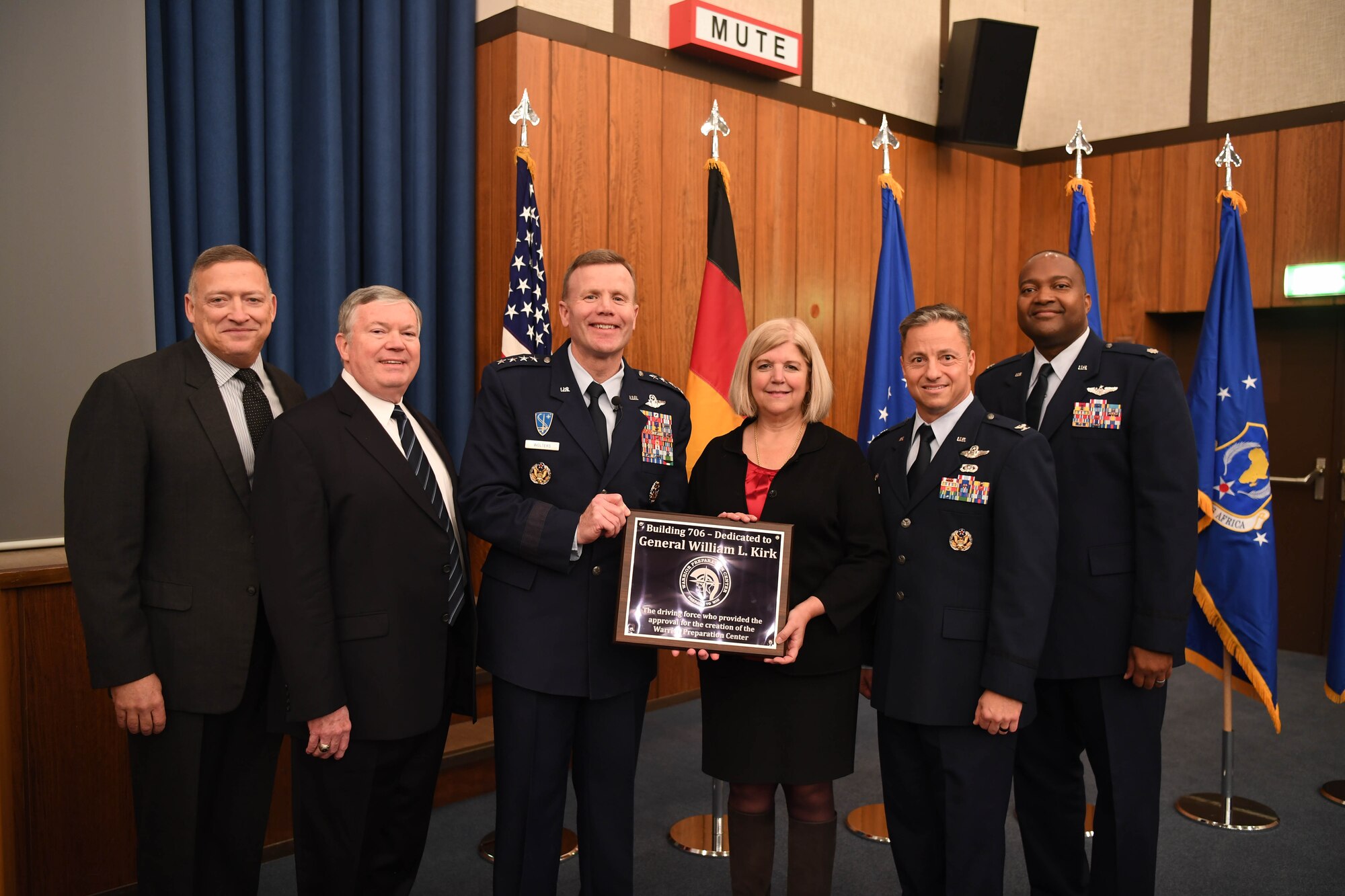 U.S. Air Force Gen. Tod D. Wolters, U.S. Air Forces in Europe-Air Forces Africa commander, presents Karen Bennett, daughter of Gen. William L. Kirk, with a plaque naming the Warrior Preparation Center Theater in honor of her father and his efforts to establish the WPC, Nov. 6, 2017, Einsiedlerhof Air Station, Germany. Kirk and his team founded the WPC to give USAFE forces the tactical advantage over adversaries in the Cold War era. (U.S. Air Force photo by Staff Sgt. Rachelle Coleman)