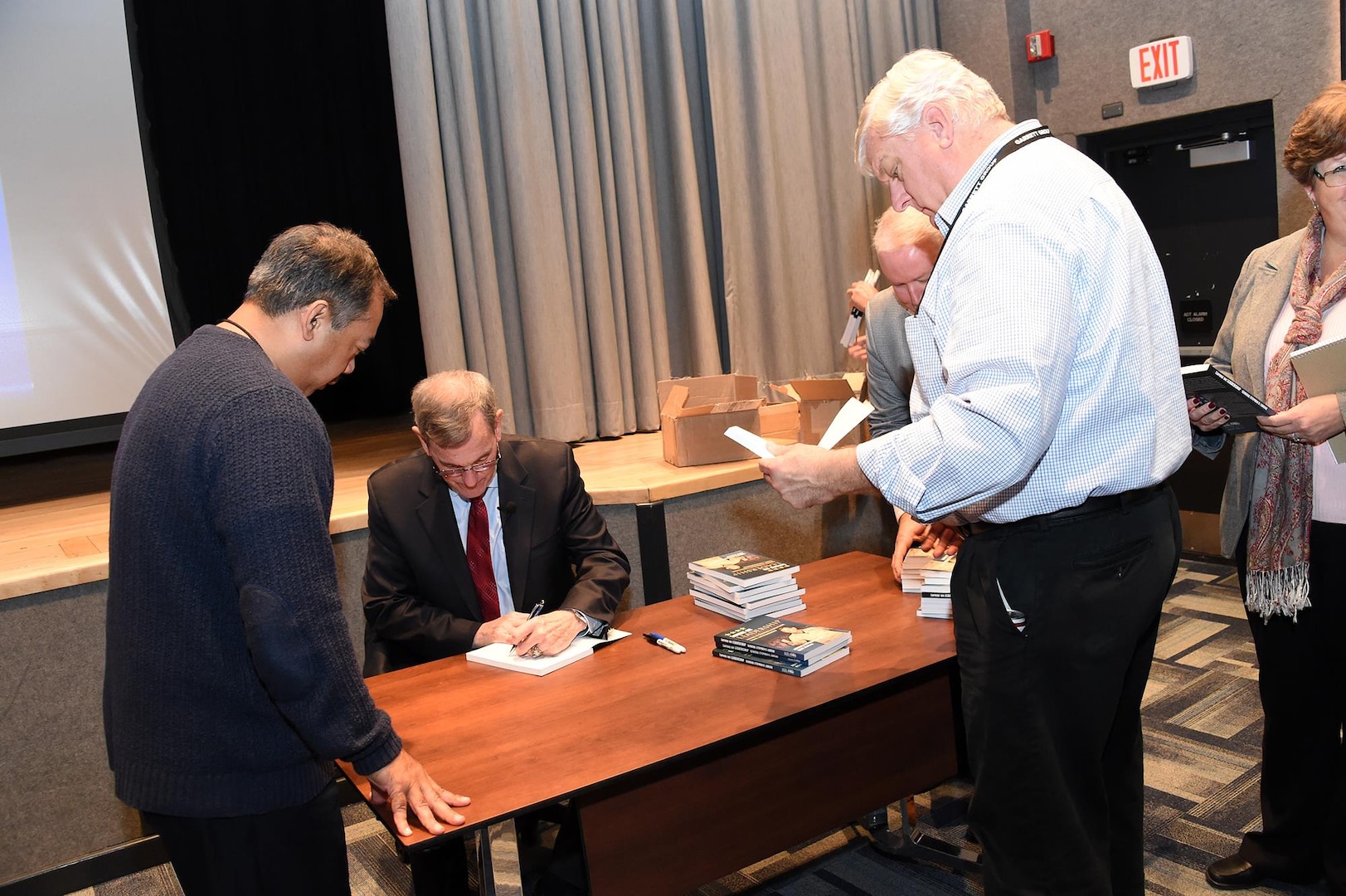 Retired U.S. Air Force Gen. Stephen Lorenz signs copies of his book, titled Lorenz on Leadership, after his presentation to members of U.S. Strategic Command at Offutt Air Force Base, Neb., Nov. 6, 2017. Lorenz, who retired as commander of Air Education and Training Command, discussed the traits and practices of effective leaders based on his experience as a military officer and commander.