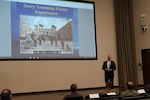 Patrick M. O’Rourke, Sr., former Derry Township police chief and current security manager with the Global Security team at the Hershey Company speaks during a force protection lecture series which highlighted photos of the 2011 flooding in Hershey, Pennsylvania, and the efforts of the Derry Township Police Department on Oct. 27 at DLA Distribution Susquehanna, Pennsylvania.