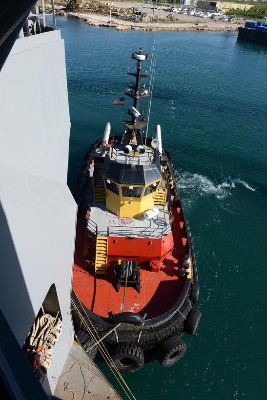 A tug boat eases Military Sealift Command’s USNS Brittin into the Port of Ponce, Puerto Rico, Nov. 3, 2017.