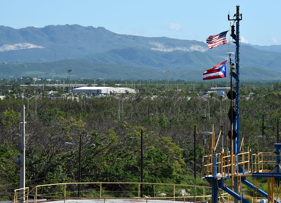 A U.S. flag and Puerto Rico flag fly high above the Port of Ponce, Puerto Rico, Nov. 3, 2017.