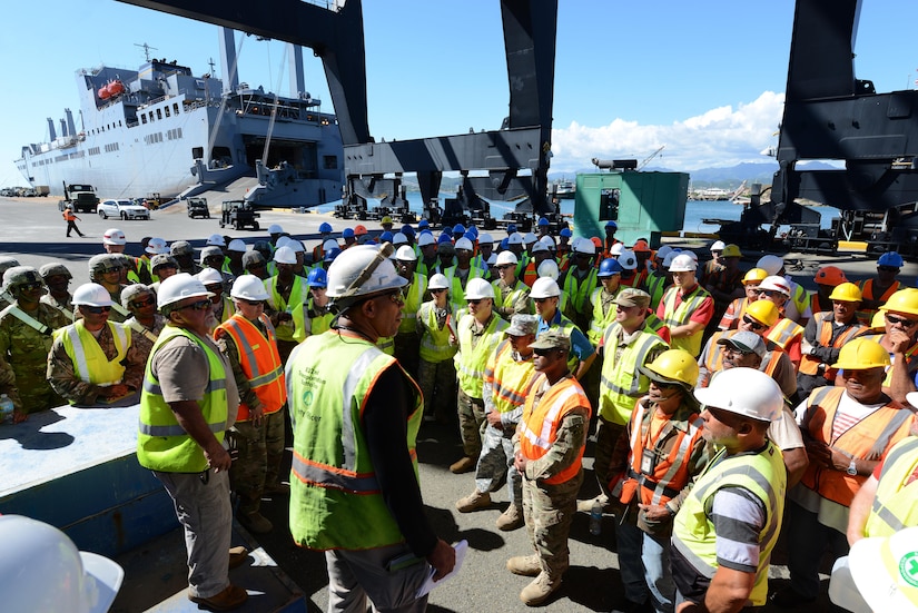 Carlos Vila, Southeastern Atlantic Detachment, 832nd Transportation Battalion, 597th Trans. Brigade marine cargo specialist, provides safety guidance to members of the 597th Trans. Bde., the Federal Emergency Management Agency, local dockworkers and other mission partners before unloading Military Sealift Command’s USNS Brittin at the Port of Ponce, Puerto Rico, Nov. 3, 2017.