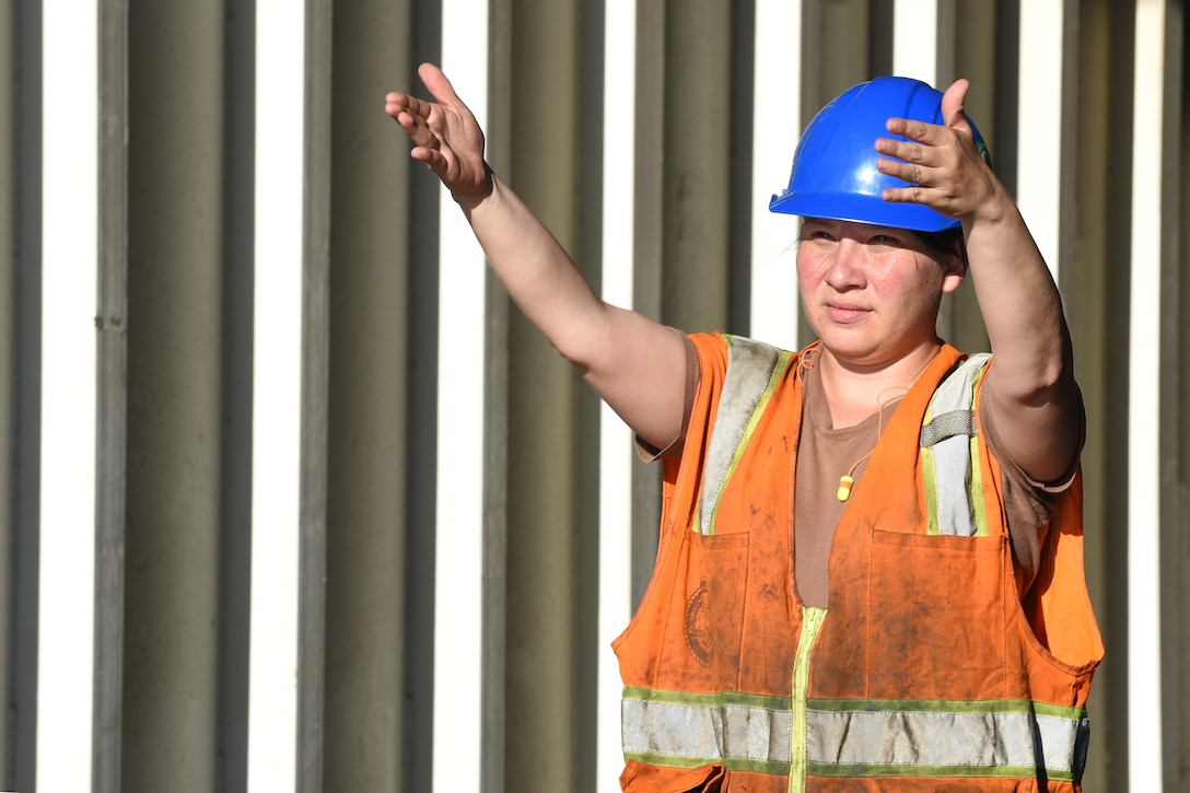 U.S. Navy Logistics Specialist Seaman Jennifer Perez, Navy Cargo Handling Battalion One from Williamsburg, Va., guides vehicles off the weather deck of Military Sealift Command’s USNS Brittin at the Port of Ponce, Puerto Rico, Nov. 3, 2017.