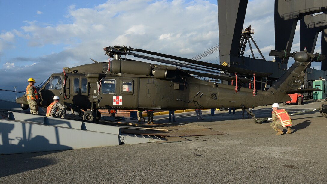 U.S. Navy Sailors assigned to U.S. Navy Cargo Handling Battalion One from Williamsburg, Va., and U.S. Army Soldiers from C Company, 2nd Battalion, 211th Aviation Regiment, Minnesota National Guard, unload a UH-60 Black Hawk medical evacuation helicopter from Military Sealift Command’s USNS Brittin at the Port of Ponce, Puerto Rico, Nov. 3, 2017.