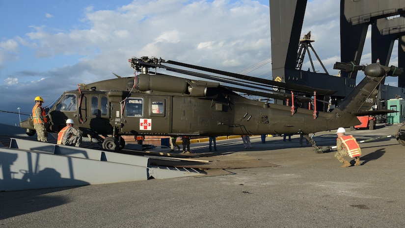 U.S. Navy Sailors assigned to U.S. Navy Cargo Handling Battalion One from Williamsburg, Va., and U.S. Army Soldiers from C Company, 2nd Battalion, 211th Aviation Regiment, Minnesota National Guard, unload a UH-60 Black Hawk medical evacuation helicopter from Military Sealift Command’s USNS Brittin at the Port of Ponce, Puerto Rico, Nov. 3, 2017.