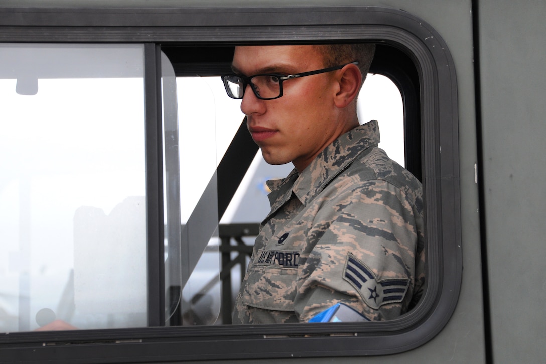 An Air National Guardsman sits in a vehicle.