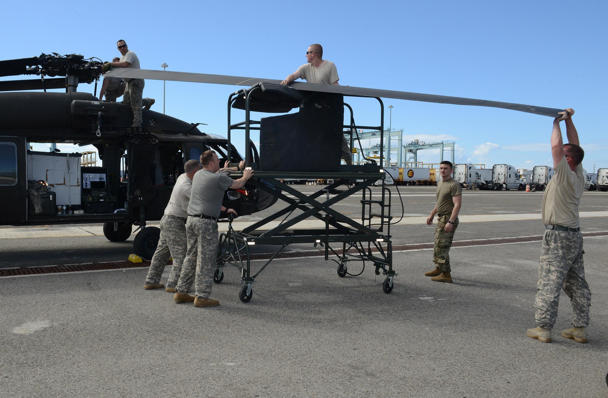 U.S. Army Soldiers from C Company, 2nd Battalion, 211th Aviation Regiment, Minnesota National Guard, prepare a UH-60 Black Hawk medical evacuation helicopter for use at the Port of Ponce, Puerto Rico, Nov. 4, 2017.
