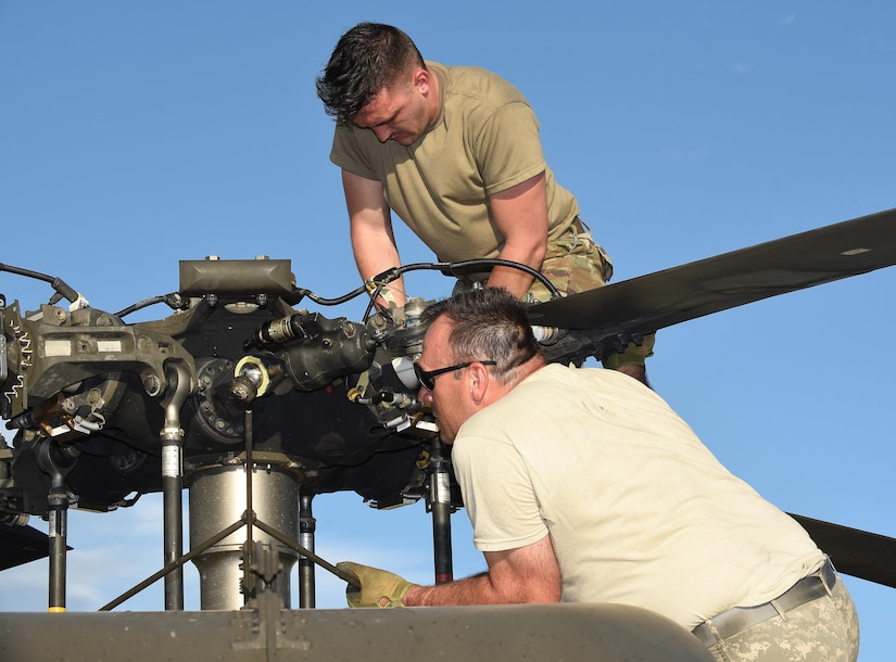 U.S. Army Specialist Alec Miller, C Company, 2nd Battalion, 211th Aviation Regiment, Minnesota National Guard UH-60 Black Hawk helicopter maintainer, and Staff Sgt. Todd Martinez, helicopter crew chief, prepare the blades on a Black Hawk after unloading it from Military Sealift Command’s USNS Brittin at the Port of Ponce, Puerto Rico, Nov. 4, 2017.