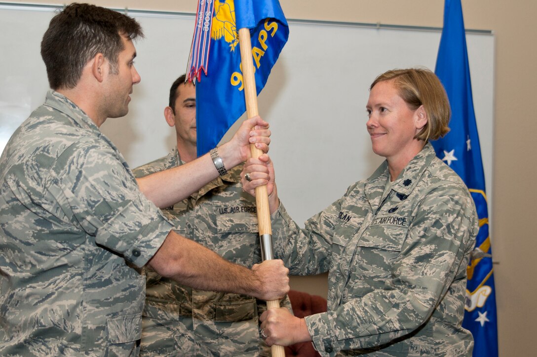 With the passing of the guidon from U.S. Air Force Reserve Col. Christopher T. Lay, commander, 913th Airlift Group, Lt. Col. Tara E. Nolan takes the reins of the 96th Aerial Port Squadron during a assumption of command ceremony at Little Rock Air Force Base, Ark., Nov. 4, 2017.